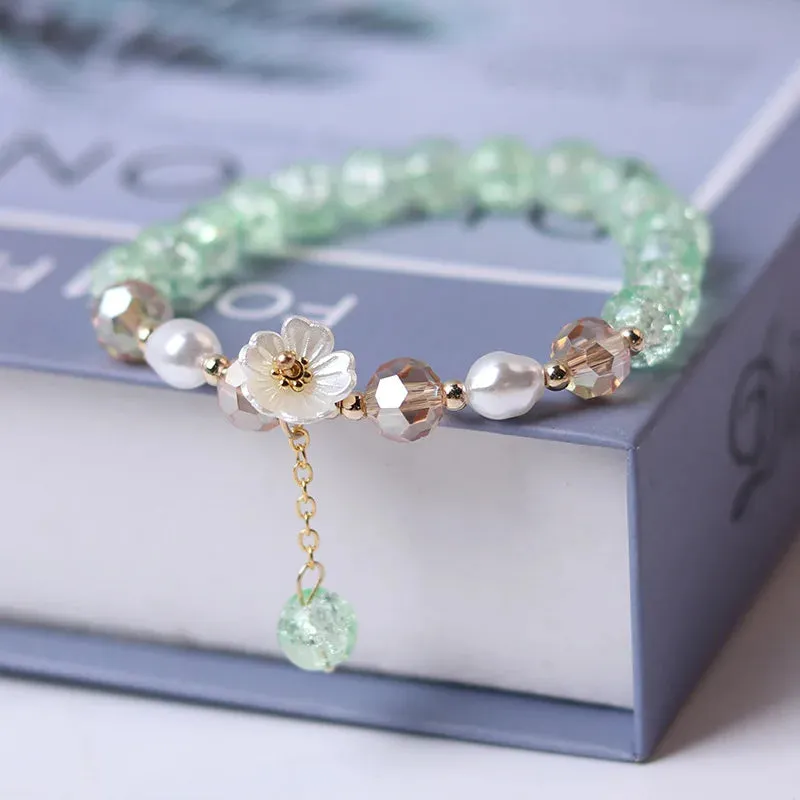 Bracelet ajustable avec fleur blanche et perles de cristal mauves, vertes ou blanches (5 coloris)