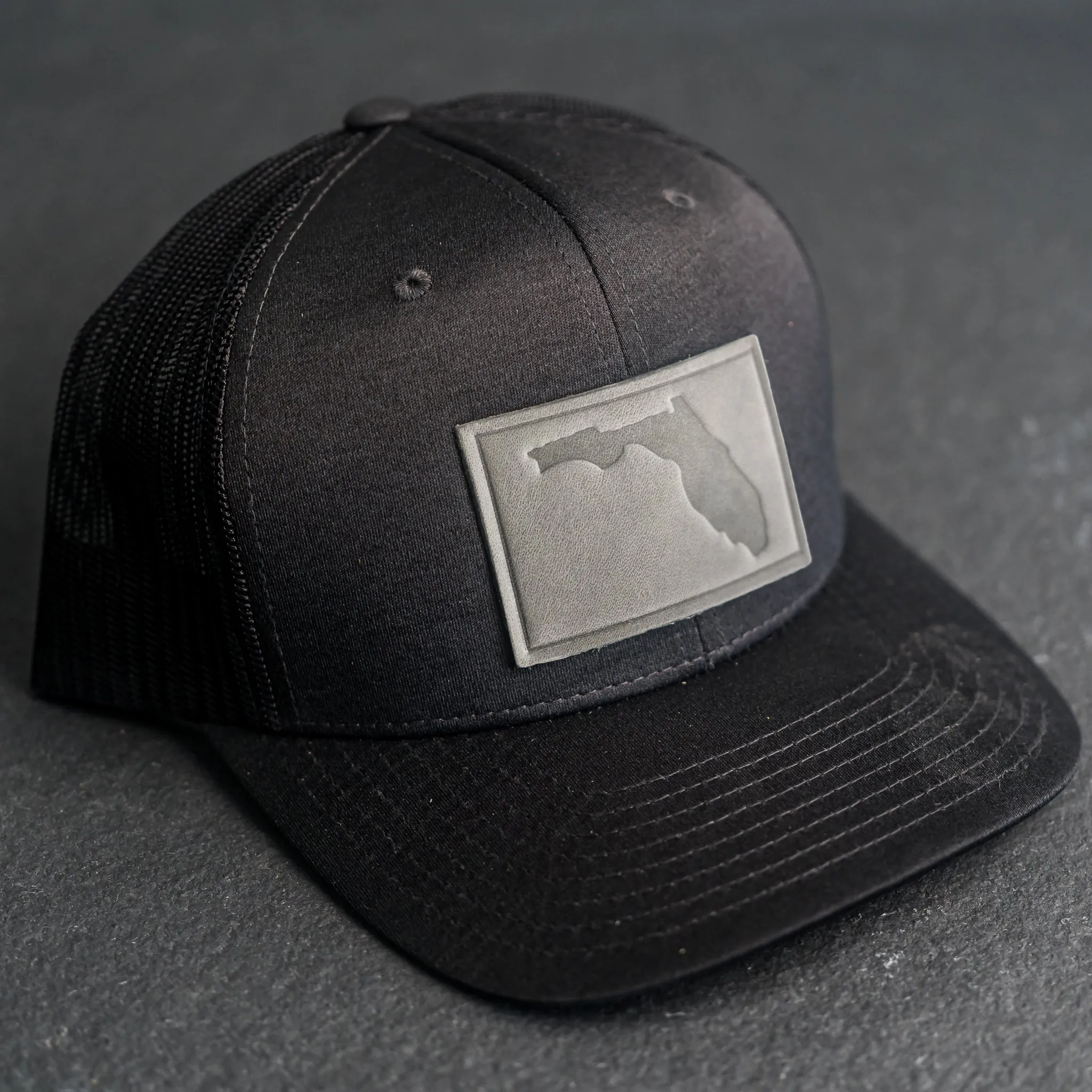 Leather Patch Performance Style Trucker Hat - Florida Stamp