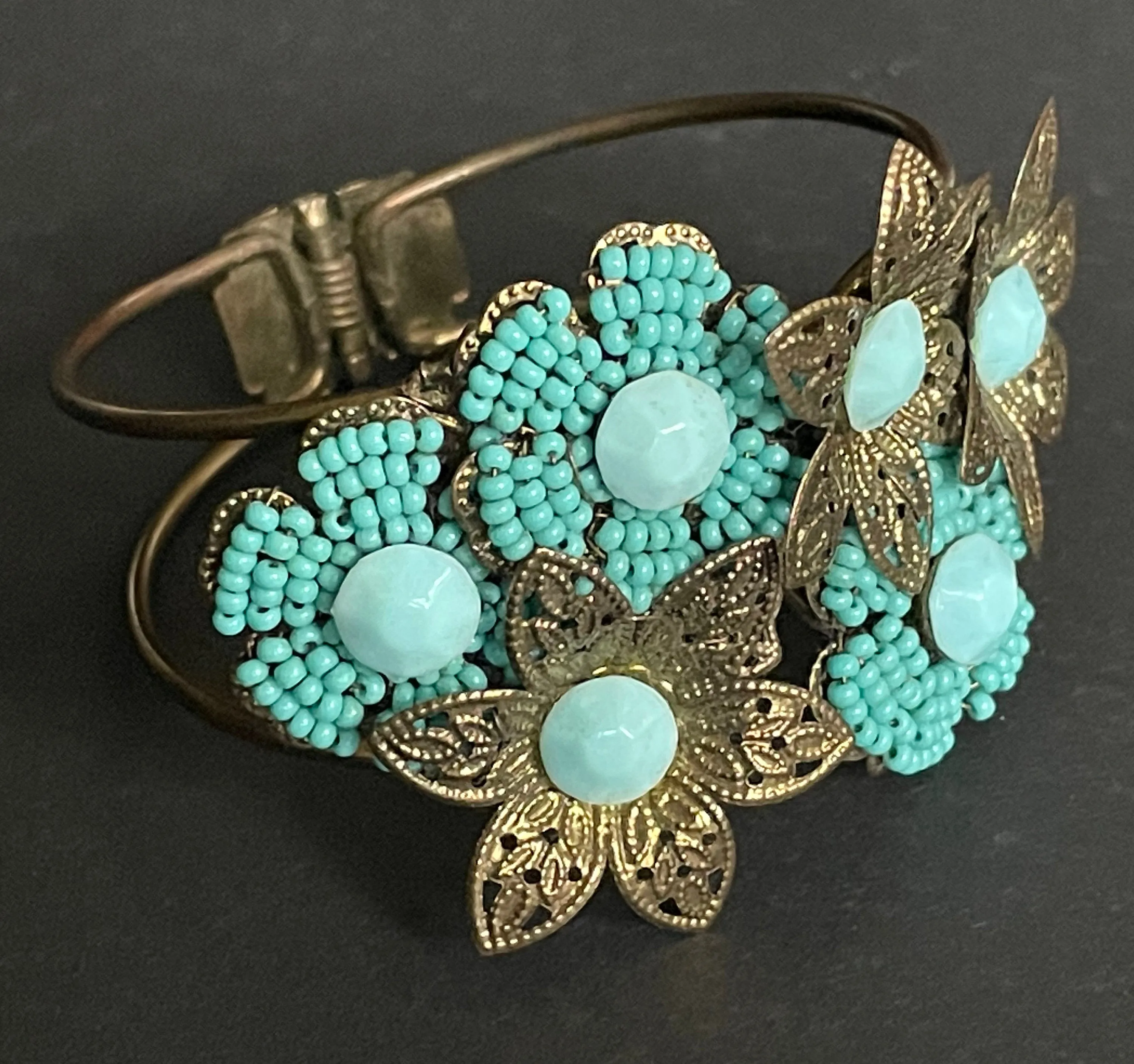 Vintage early Miriam Haskell turquoise blue glass beaded floral clamper bangle with intricate micro beading and gold tone filigree